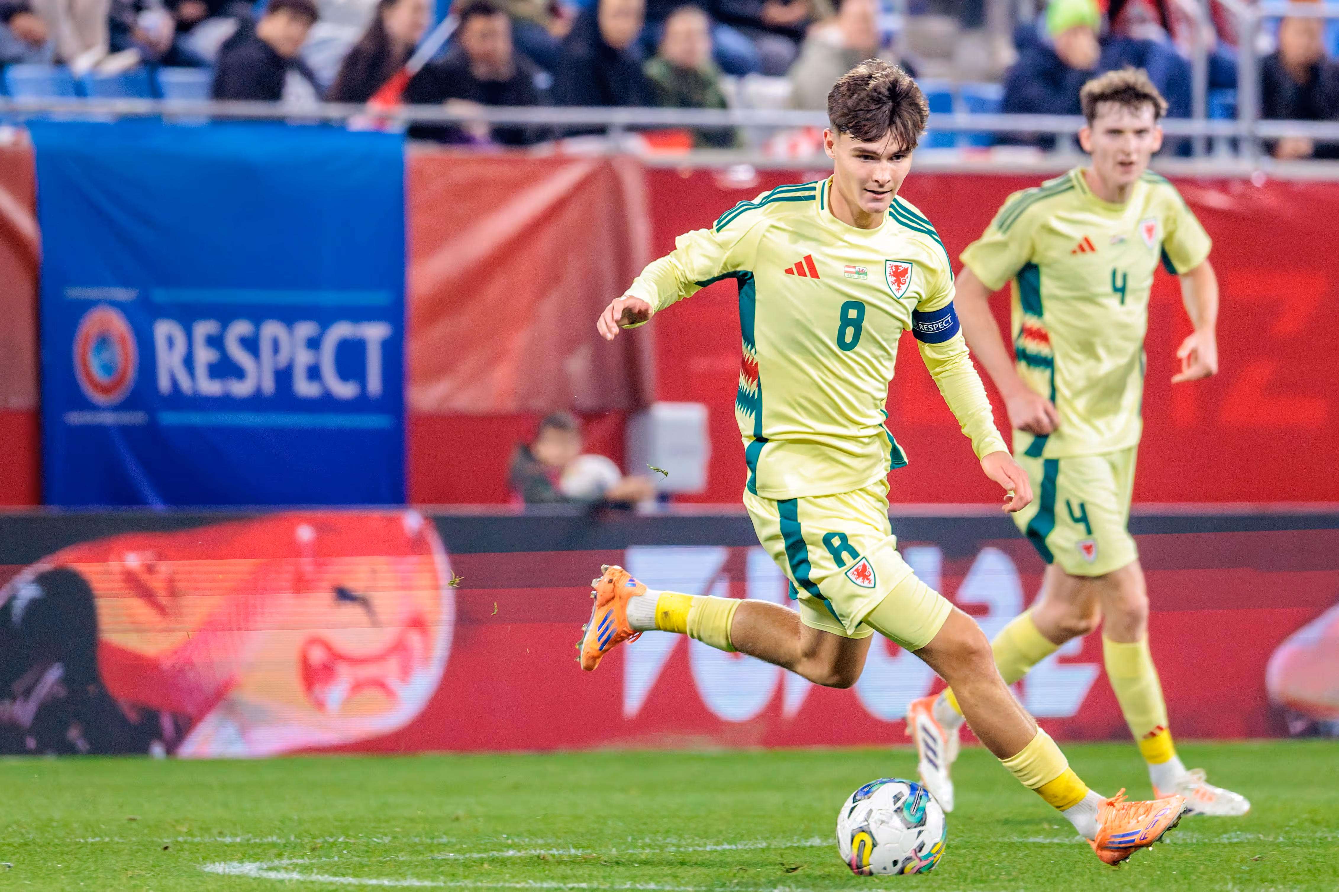 Der walisische U21-Kapitän Charlie Crew führt im hellgrünen Trikot mit der Nummer 8 den Ball während des EM-Qualifikationsspiels am Fuß