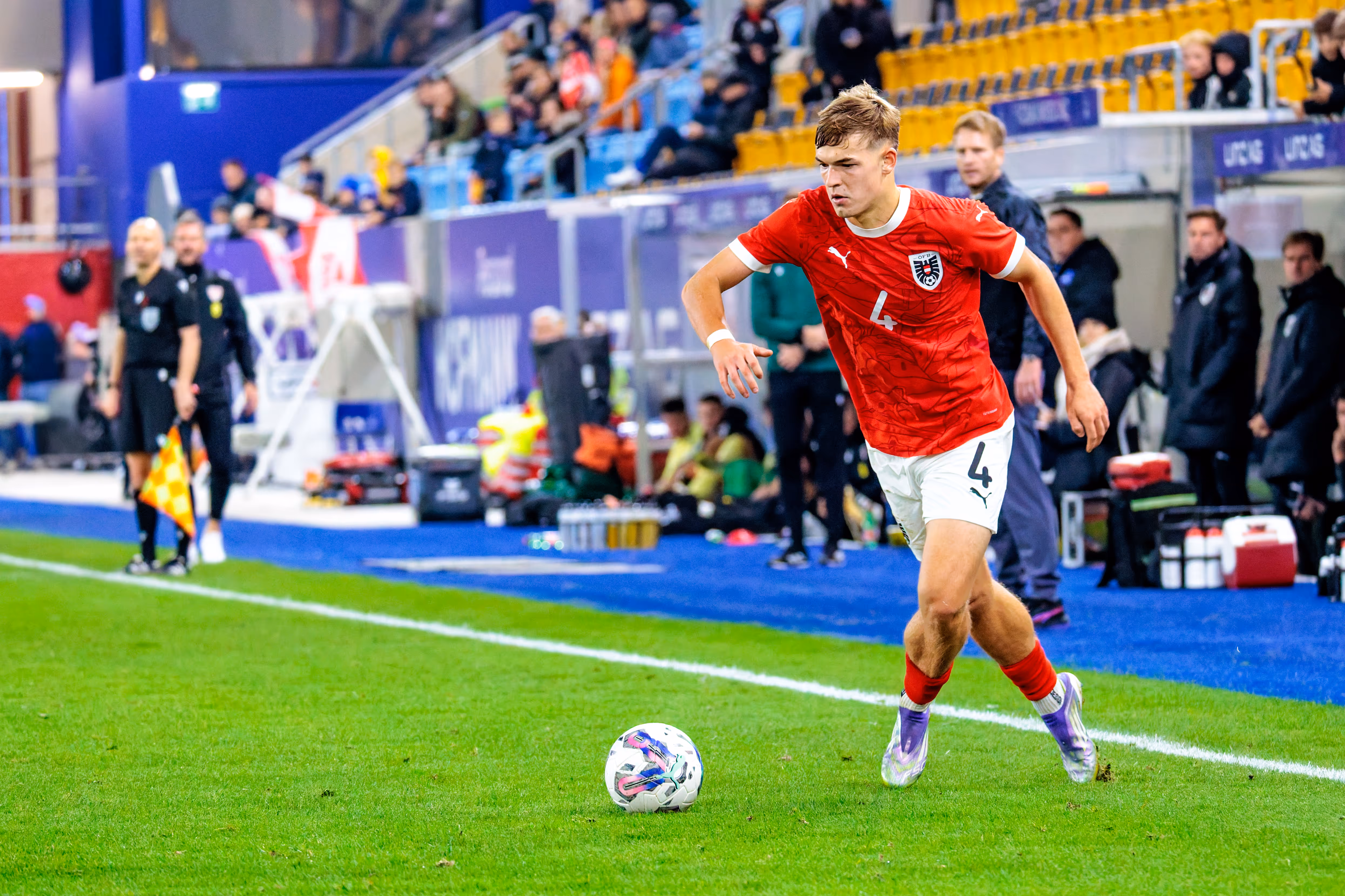Der österreichische U21-Nationalspieler David Piczka dribbelt im roten Trikot mit der Nummer 4 dynamisch am Ball
